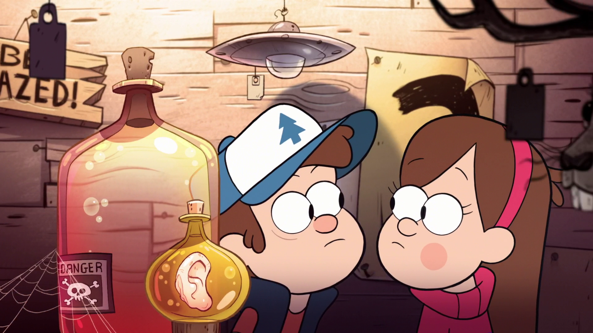 A snapshot from the intro of Gravity Falls. The twin siblings Dipper and Mabel Pines peruse a wide array of fake cryptid and supernatural attractions inside one of the Mystery Shack's rooms.